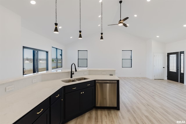 kitchen featuring high vaulted ceiling, a sink, open floor plan, dark cabinetry, and dishwasher