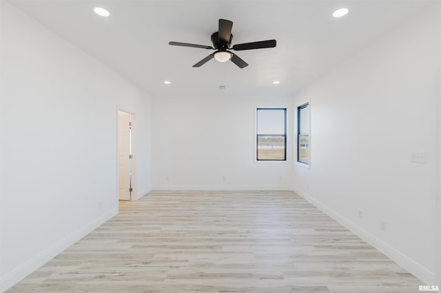 unfurnished room featuring light wood-type flooring, baseboards, and recessed lighting