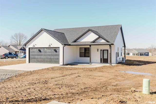 modern inspired farmhouse featuring a garage, driveway, and a shingled roof