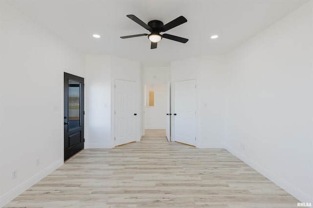 unfurnished room with a ceiling fan, recessed lighting, light wood-style flooring, and baseboards