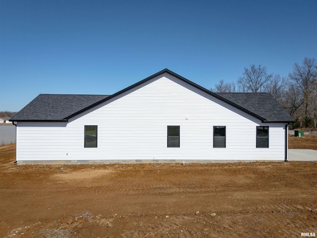 view of side of property with a shingled roof