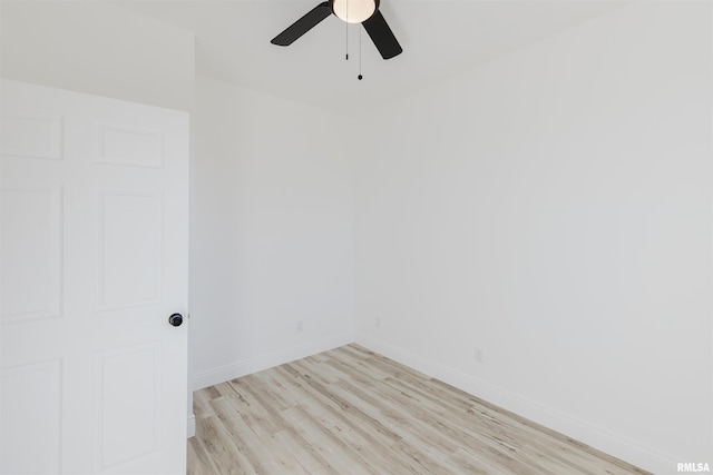 empty room featuring ceiling fan, light wood finished floors, and baseboards