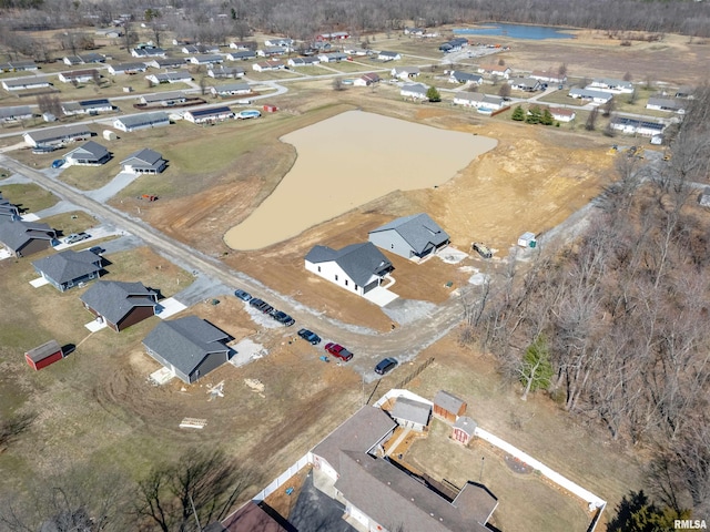 drone / aerial view with a water view and a residential view