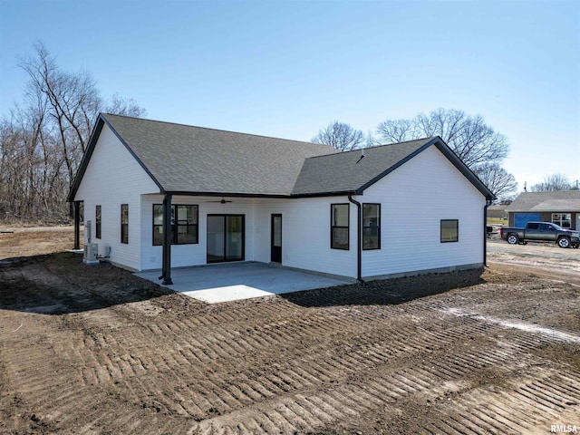 modern inspired farmhouse featuring a patio area and a shingled roof