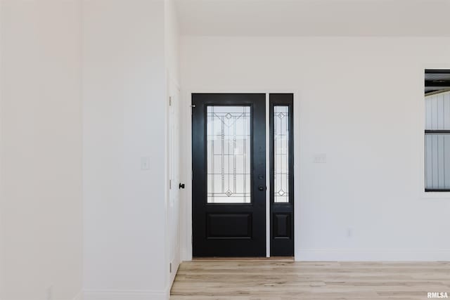 entrance foyer with light wood finished floors and baseboards