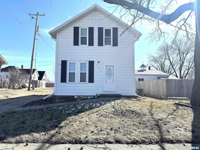 view of front of property with fence and central AC unit