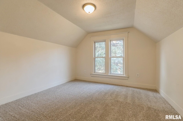 bonus room featuring baseboards, lofted ceiling, carpet, and a textured ceiling