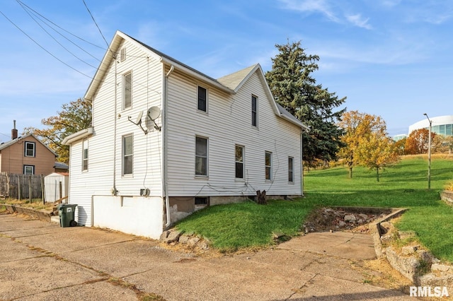 view of side of property with a lawn