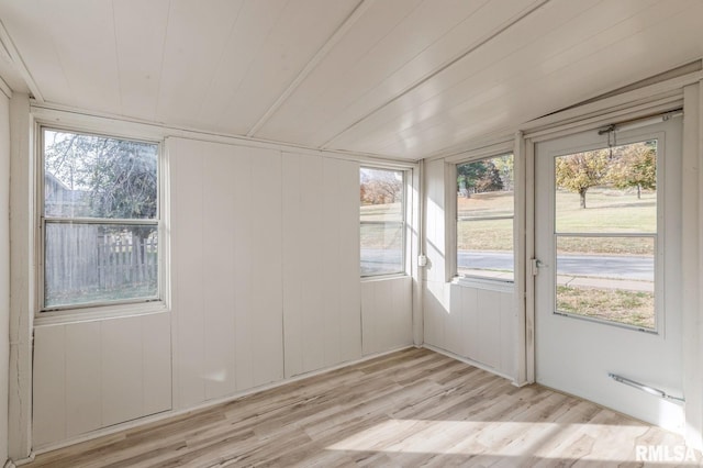 unfurnished sunroom featuring a wealth of natural light and wooden ceiling