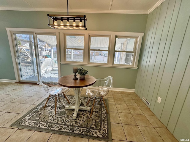 dining room with an inviting chandelier, crown molding, light tile patterned floors, and visible vents