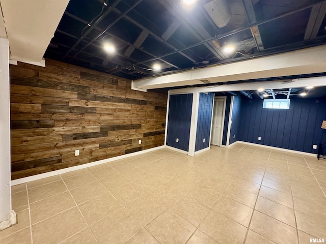 below grade area featuring wooden walls and baseboards