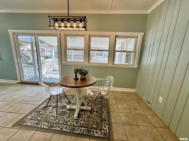 dining room featuring light tile patterned floors, visible vents, baseboards, and ornamental molding