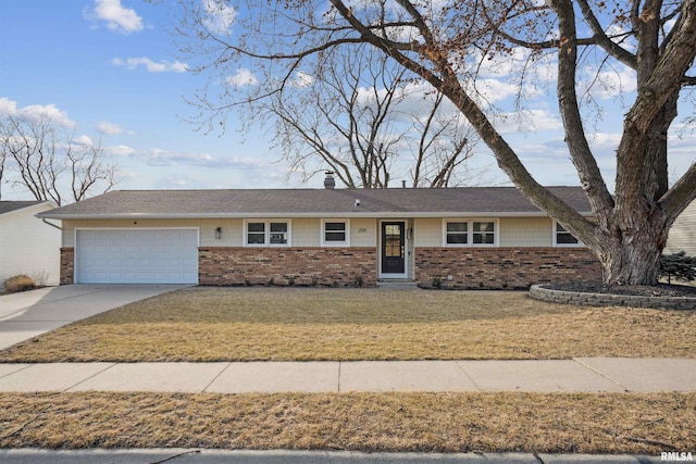 ranch-style home featuring brick siding, an attached garage, a front yard, a chimney, and driveway