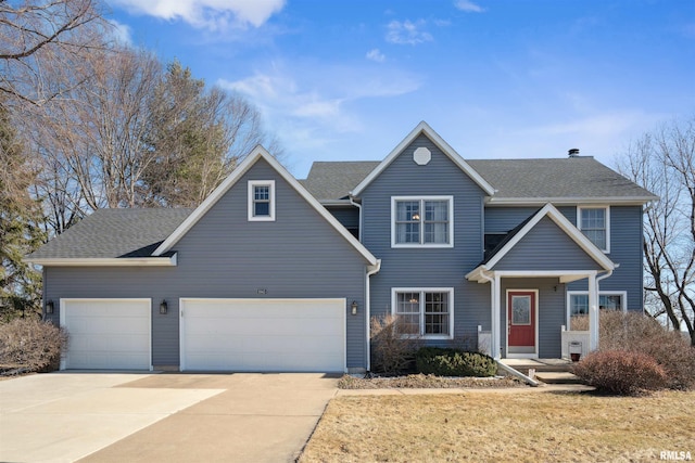 traditional-style home with concrete driveway, an attached garage, and roof with shingles