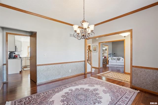 corridor with visible vents, a notable chandelier, hardwood / wood-style floors, stairway, and crown molding