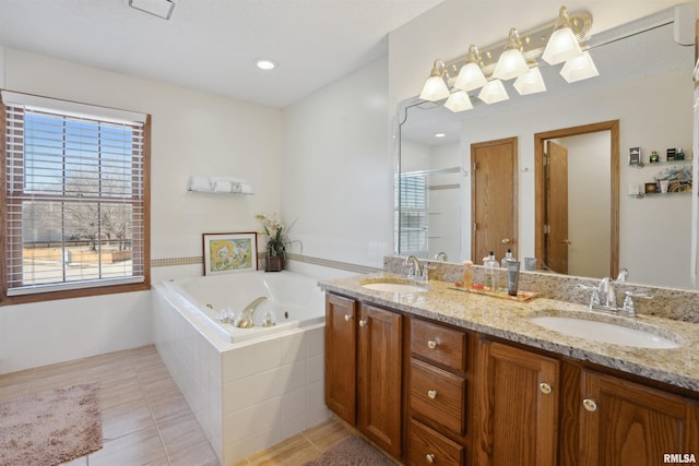 full bath with double vanity, a stall shower, a jetted tub, and a sink