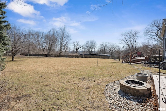 view of yard with a fire pit and a deck