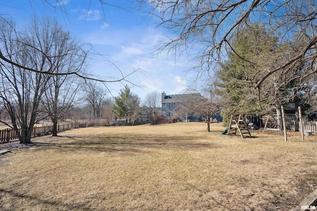 view of yard featuring fence and a playground