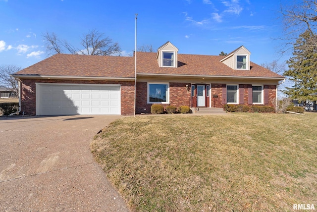 cape cod home with driveway, roof with shingles, an attached garage, a front lawn, and brick siding