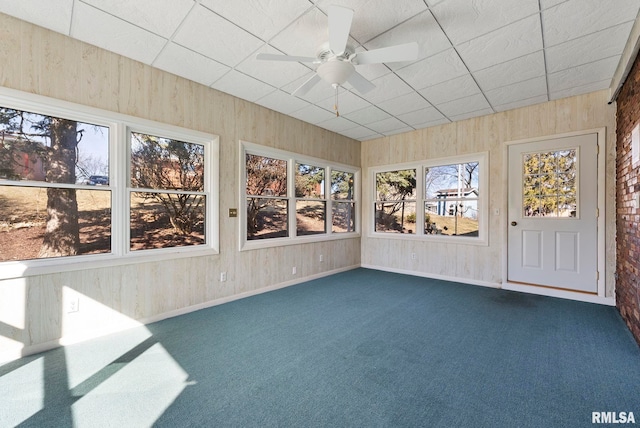 unfurnished sunroom featuring a paneled ceiling and a ceiling fan