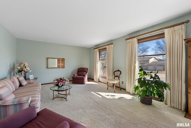 carpeted living area featuring a wealth of natural light and baseboards