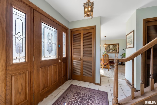 entryway with stairway, an inviting chandelier, and a healthy amount of sunlight