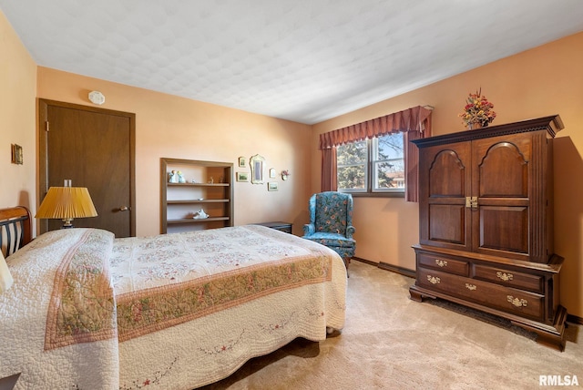 bedroom featuring baseboards and light carpet