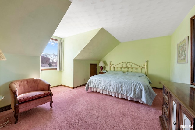 bedroom with lofted ceiling, carpet, and baseboards