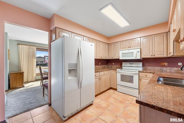 kitchen with white appliances, light tile patterned floors, stone countertops, a sink, and backsplash