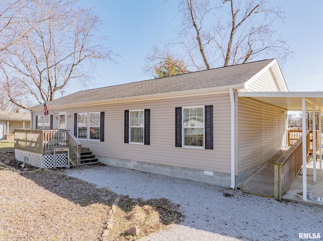 view of front of property with crawl space, an attached carport, and roof with shingles