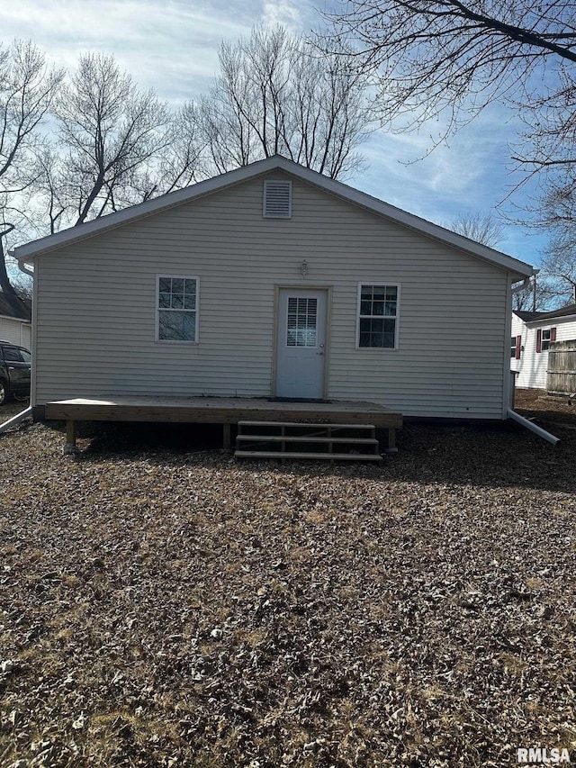 back of house featuring a deck