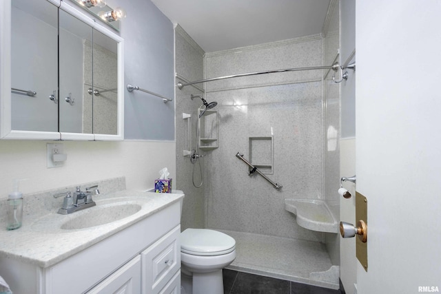 full bathroom with vanity, toilet, tile patterned flooring, and walk in shower