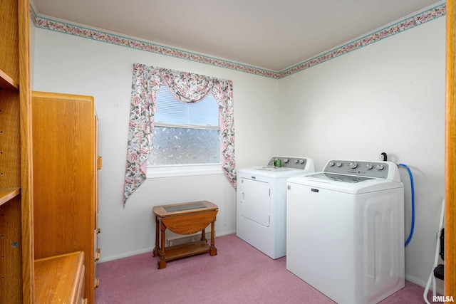 washroom with washer and dryer, baseboards, light carpet, and laundry area