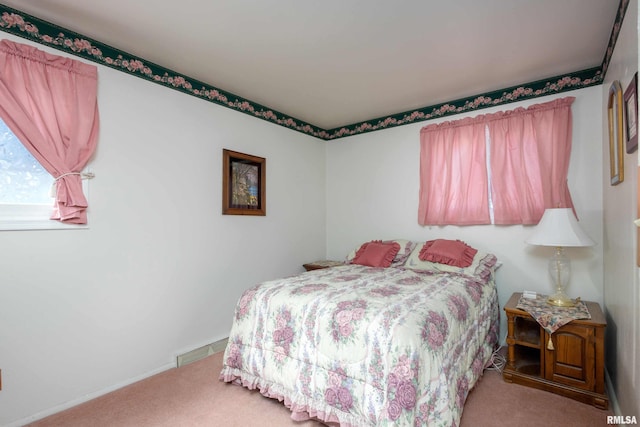 bedroom featuring baseboards, visible vents, and carpet floors