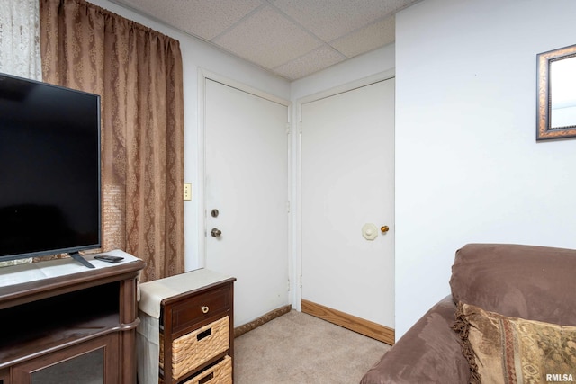 office with a paneled ceiling, light carpet, and baseboards