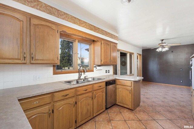 kitchen with tasteful backsplash, dishwasher, light tile patterned floors, a peninsula, and a sink