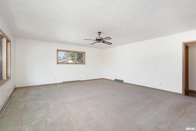 spare room with visible vents, a textured ceiling, and carpet