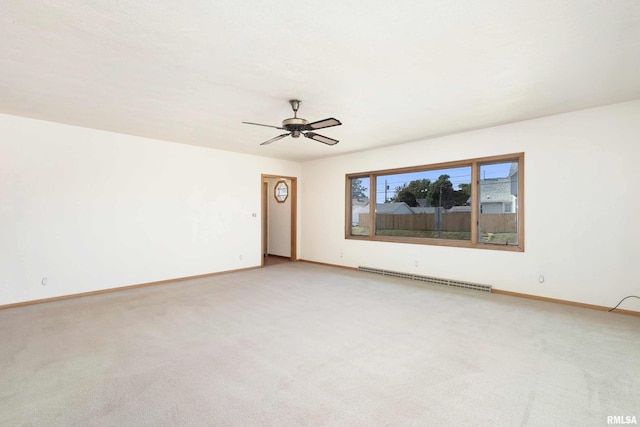 unfurnished room with light carpet, a ceiling fan, a baseboard heating unit, and baseboards