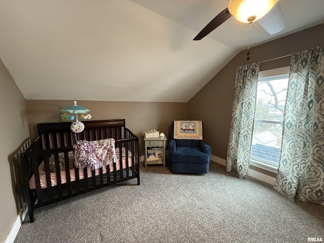 carpeted bedroom featuring ceiling fan, baseboards, and vaulted ceiling