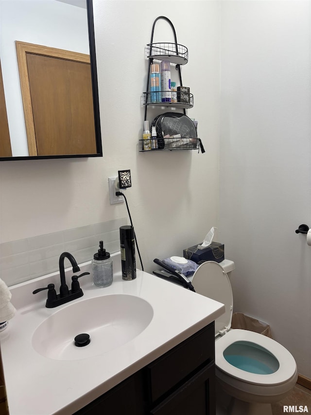 bathroom featuring vanity and toilet