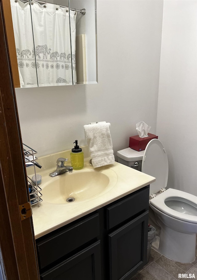 bathroom with tile patterned floors, toilet, and vanity