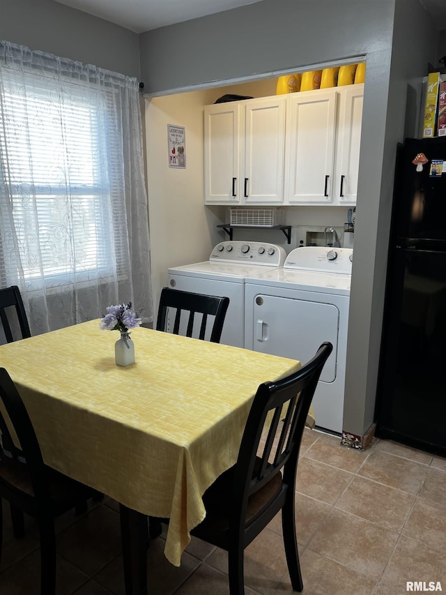 dining room with light tile patterned flooring and separate washer and dryer