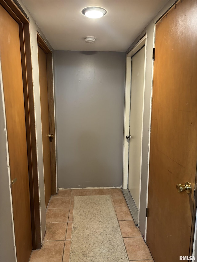 hallway with light tile patterned floors