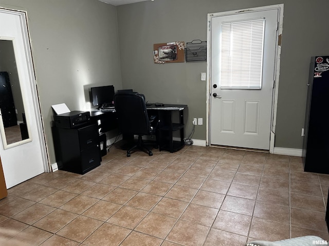 office area with light tile patterned floors and baseboards