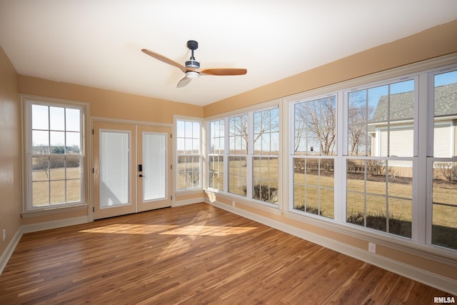 unfurnished sunroom with french doors and ceiling fan