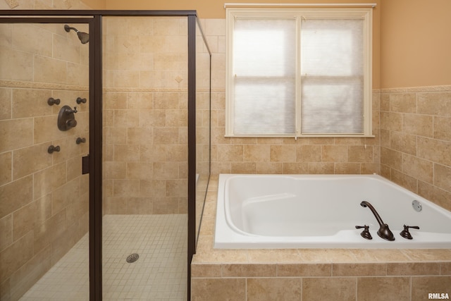 full bath featuring a bath and a shower stall