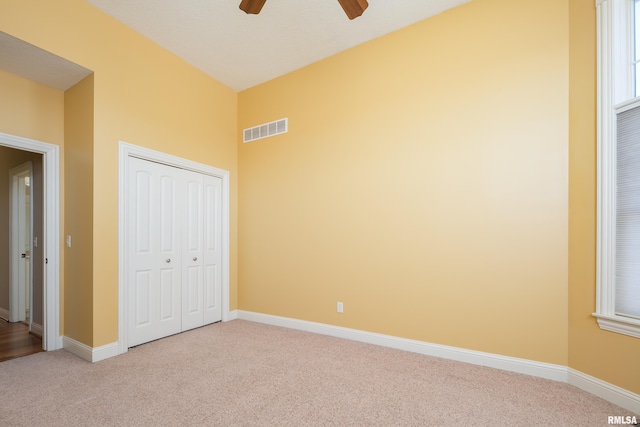 unfurnished bedroom featuring carpet, visible vents, and baseboards