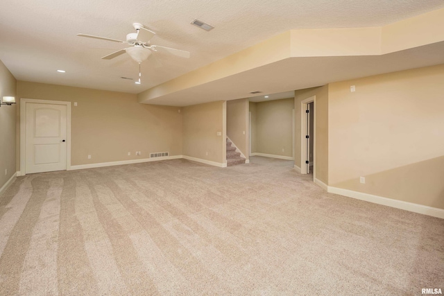 spare room with visible vents, light carpet, baseboards, and stairs