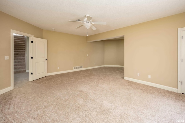 unfurnished room featuring a ceiling fan, visible vents, carpet floors, and baseboards