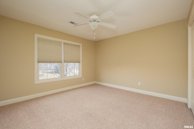 empty room with a ceiling fan, baseboards, visible vents, and light carpet